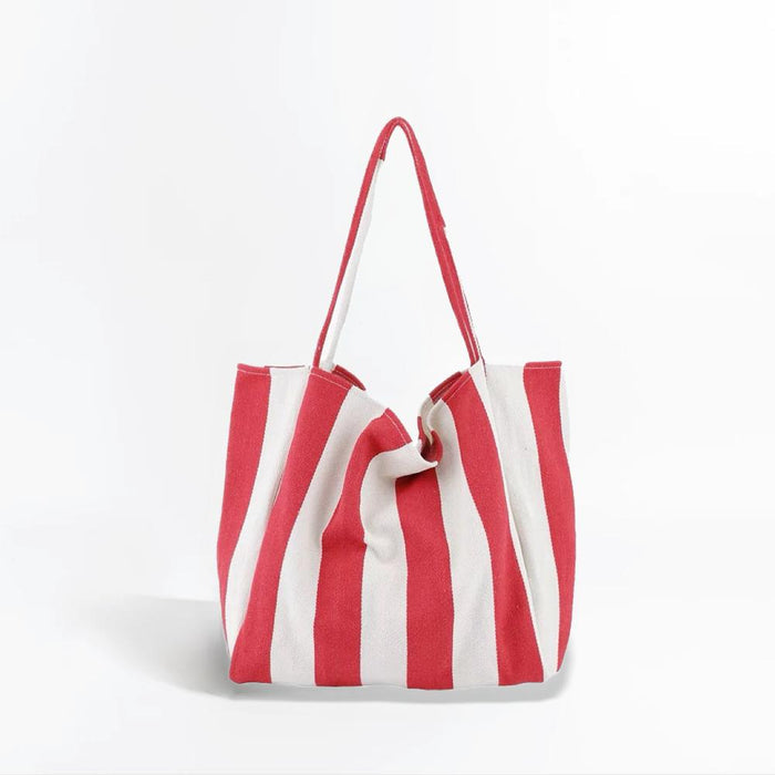 Flat lay of Wide Stripe Canvas Tote Bag in red, great for everyday carry and travel.