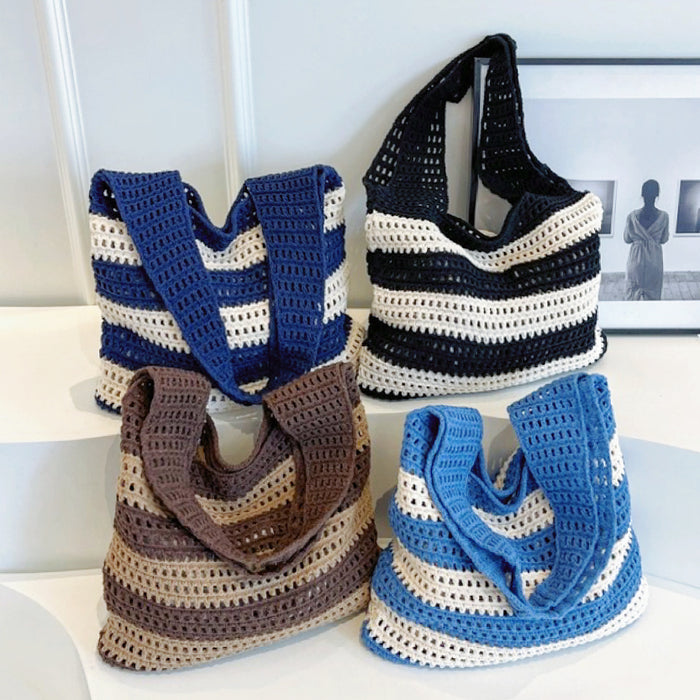 Front view of Four wide stripe crochet bags: navy blue, black, brown, and light blue.