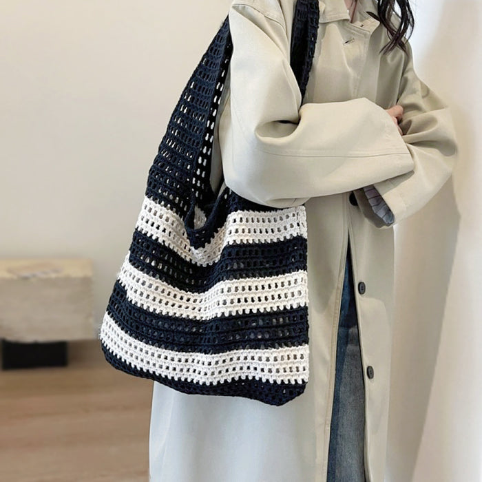 Model carrying a Wide Stripe Crochet Bag in black, ideal for city walks and gifting.