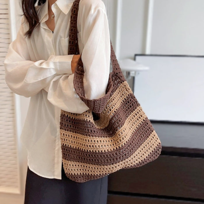 Model carrying a brown striped bag on the shoulder, easy for commuting and weekends.