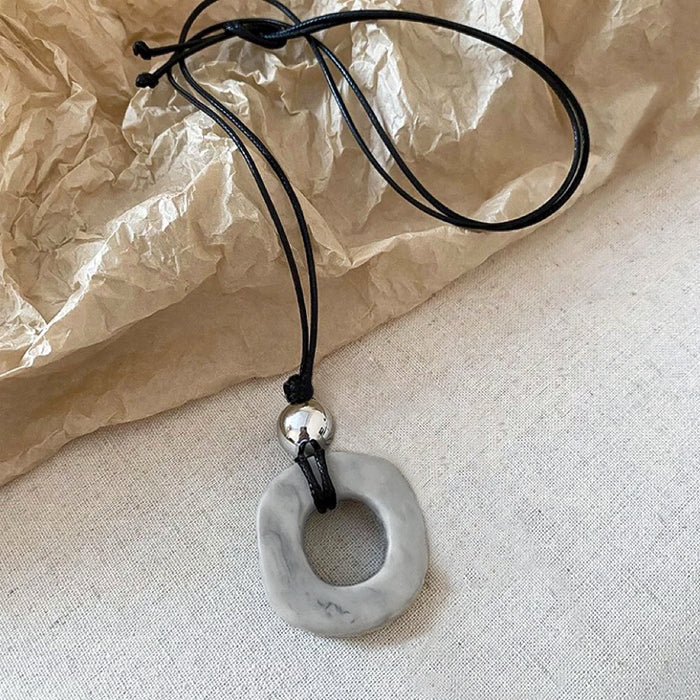 Folded view of Wild Grace Geometric Pendant Necklace in Grey, easy to style.