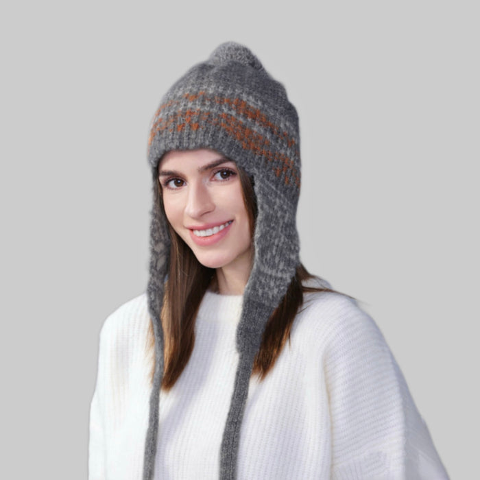 Model wearing grey Winter Isle Ear Flap Hat, showcasing a cozy knit build designed for maximum winter insulation.