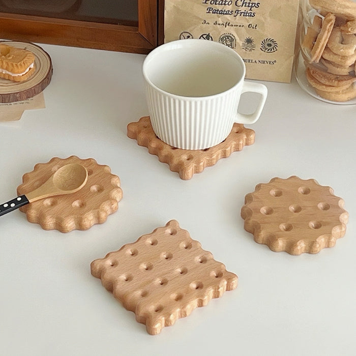 Front view of 4 pieces of Light brown wooden biscuit coasters in round and square shapes.