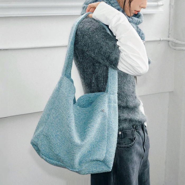 Model carrying a blue Woolish Cozy Tote Bag on the shoulder, great for daily carry and travel.