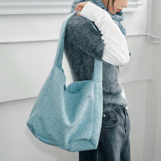 Model carrying a blue Woolish Cozy Tote Bag on the shoulder, great for daily carry and travel.