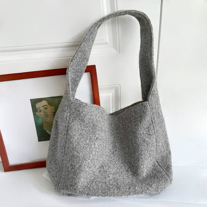Folded view of Woolish Cozy Tote Bag in gray, easy for commuting and weekends.