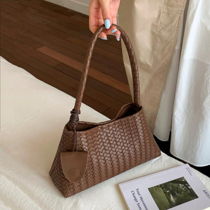 Model carrying a beige bag handheld, easy for commuting and weekends.
