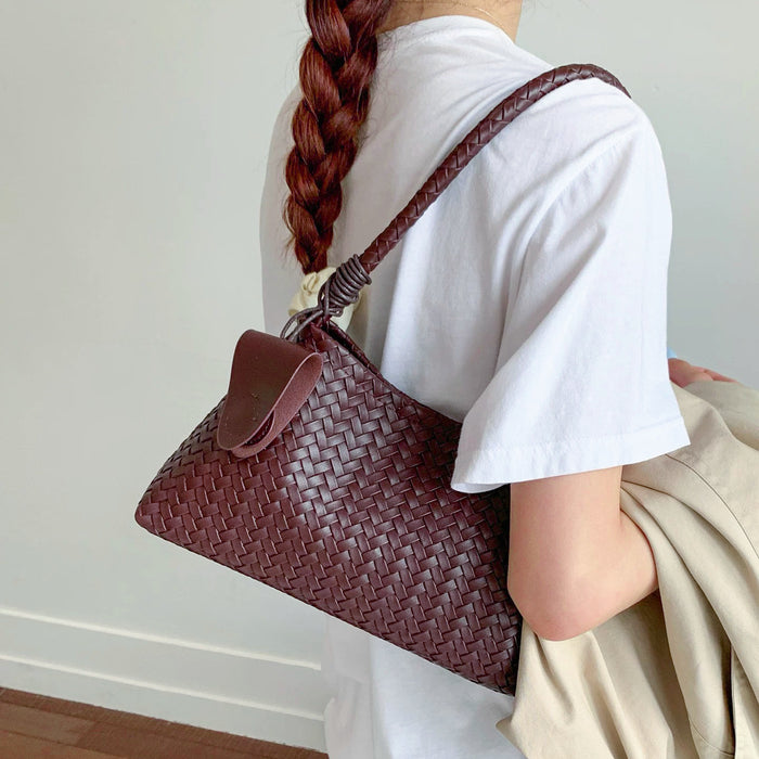 Model carrying a burgundy shoulder bag, ideal for city walks and gifting.