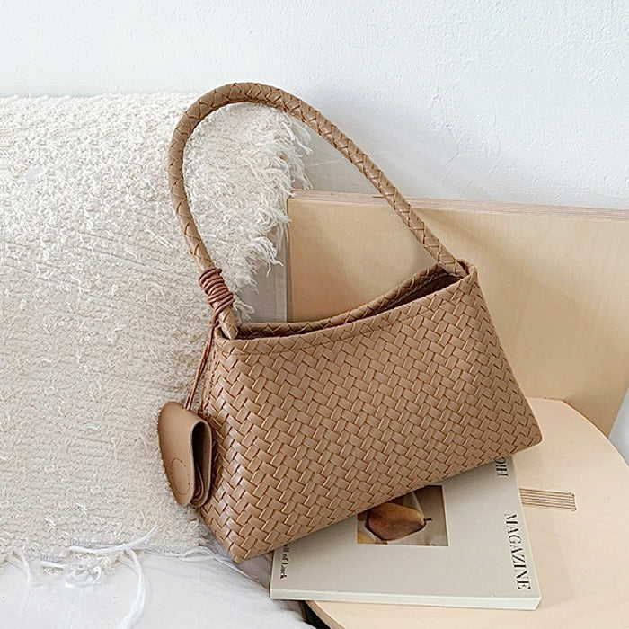 Flat lay of Woven Leather Bag With Glasses Holder in khaki, great for everyday carry and travel.