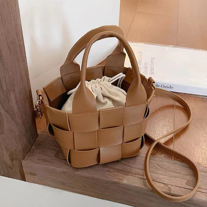 Front view of Brown woven PU leather mini basket bag with grab handle and detachable strap, great for everyday carry.