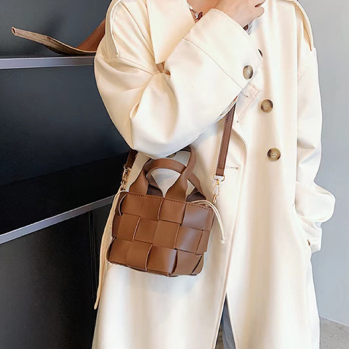 Model carrying a brownWoven Leather Mini Basket Bag as crossbody, easy for commuting and weekends.