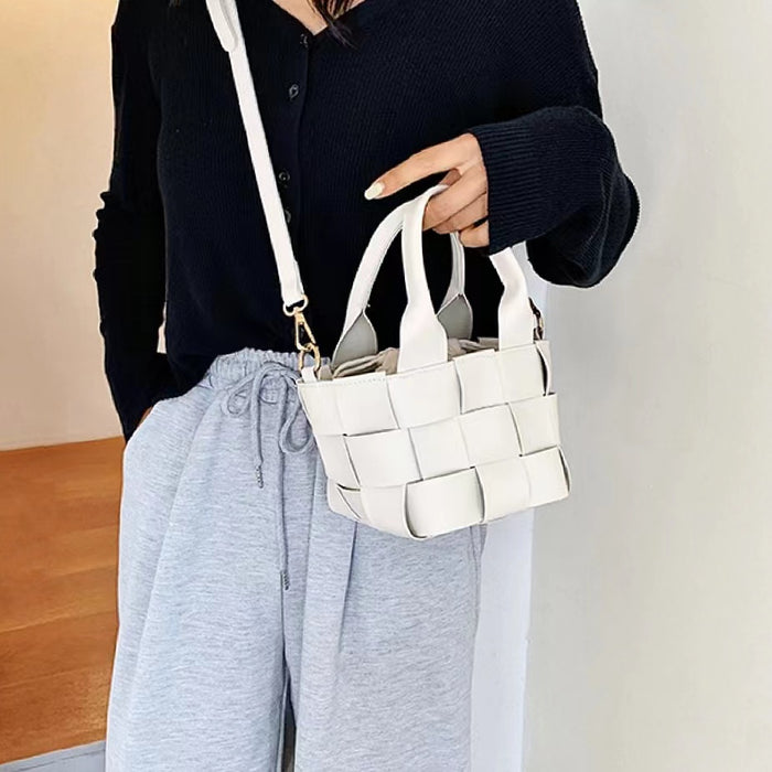 Model holding a white Woven Leather Mini Basket Bag, great for daily carry and travel.