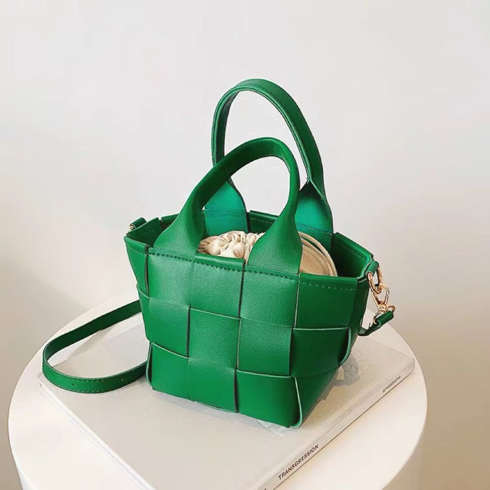 Angled view of Woven Leather Mini Basket Bag in green, great for everyday carry and travel.
