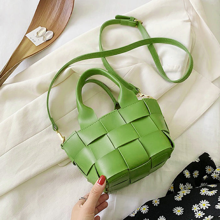 Angled view of Woven Leather Mini Basket Bag in fresh green, easy for commuting and weekends.