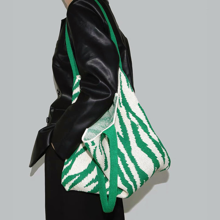 Model carrying a green white Zebra Print Knitted Tote Bag on shoulder, ideal for city walks and gifting.