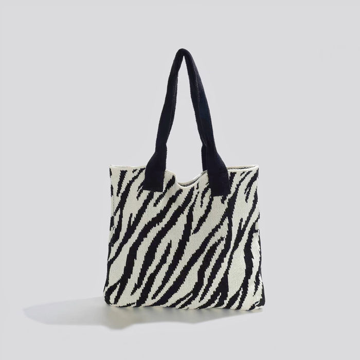 Folded view of Zebra Print Knitted Tote Bag in black and white, easy for commuting and weekends.