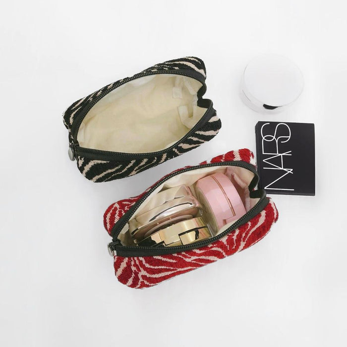 Angled view of Zebra Print Makeup Bag, showcasing the interior.