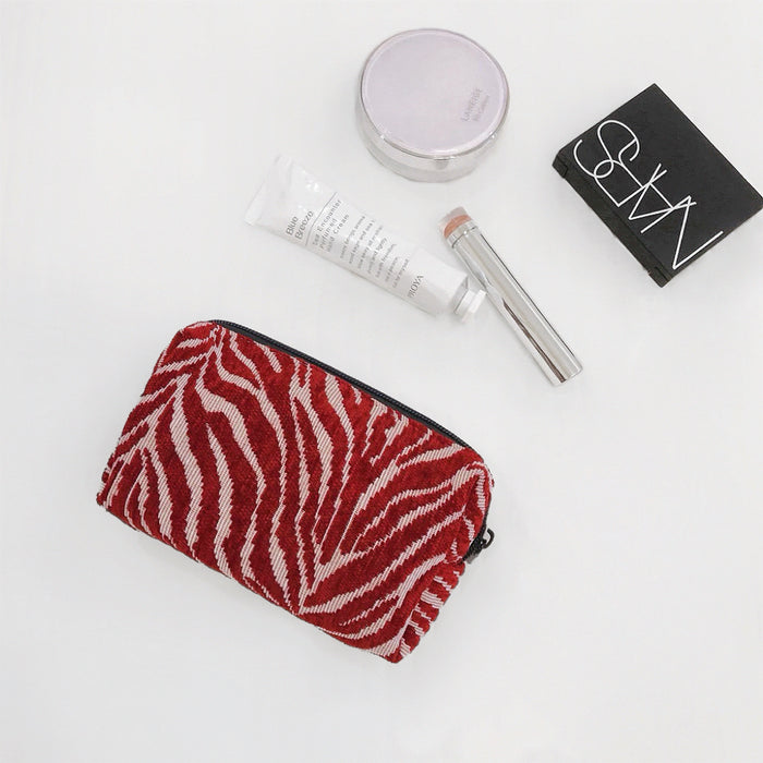 Close-up of Zebra Print Makeup Bag in red, easy to pack for trips and daily use.
