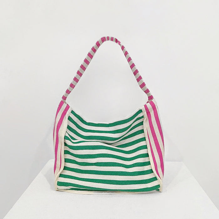 Front view of Zesty Stripe Canvas Tote Bag with green and white horizontal stripes, pink and white striped handles.