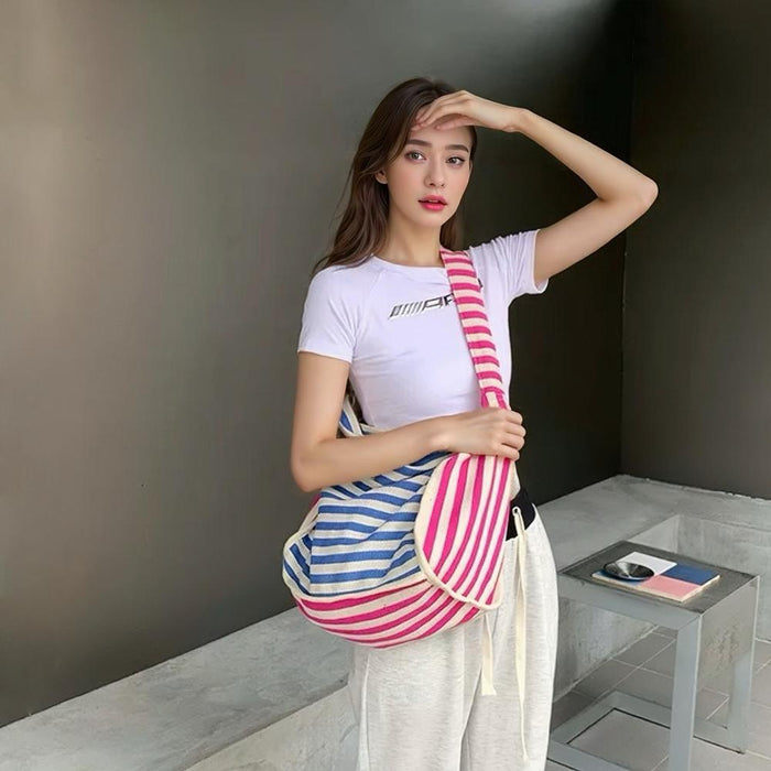 Model carrying a blue striped tote bag on the shoulder , ideal for city walks and gifting.
